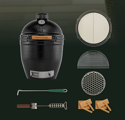 Black Onyx kamado-style grill with a textured exterior, temperature gauge, and silver metal trim, shown alongside included accessories: a round lid insert, two metal grates, a round vent insert, a long-handled tool with a green handle, a smaller hand tool with a brown handle, and two wooden starter bricks on a dark green background.